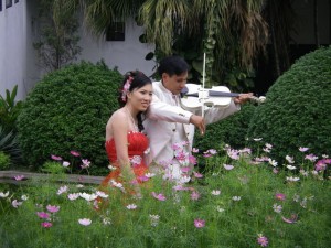 In red! with her groom also dressed elegantly