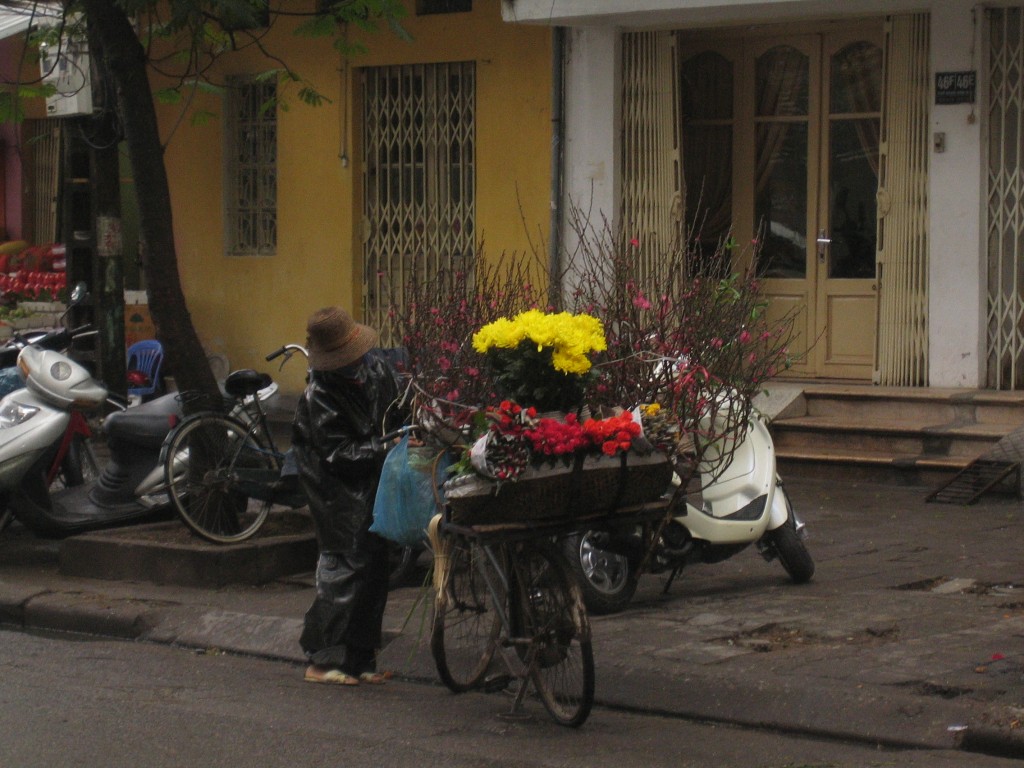 Flower vendor with blossoming peach branches